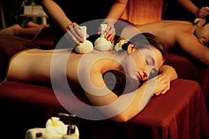 Hot herbal ball spa massage body treatment with couple customer. Quiescent