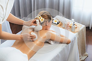 Hot herbal ball spa massage body treatment at day spa . Quiescent