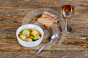 Hot Homemade Matzo Ball Soup in a Bowl Passover wine and matzah photo