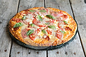 Hot Homemade Pepperoni Pizza on a rustic wooden table. Pizza wit