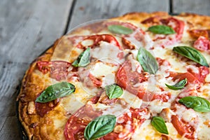 Hot Homemade Pepperoni Pizza on a rustic wooden table. Pizza wit