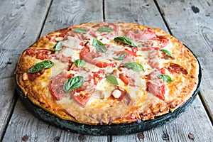 Hot Homemade Pepperoni Pizza on a rustic wooden table. Pizza wit