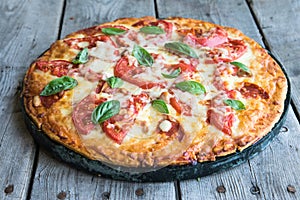 Hot Homemade Pepperoni Pizza on a rustic wooden table. Pizza wit