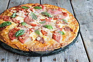 Hot Homemade Pepperoni Pizza on a rustic wooden table. Pizza wit