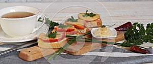 Hot homemade sandwiches with sausage, tomatoes and cheese.Natural healthy food. Sandwiches on a wooden background for tea