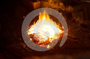 Hot horseshoe in forge.