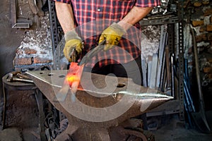 Hot iron forging on anvil. Handmade blacksmith