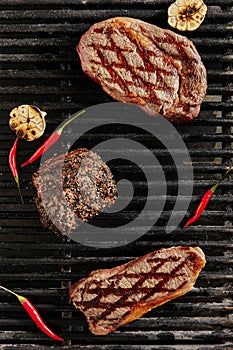 Hot Juicy Ribeye Steak on Barbecue Grill Background