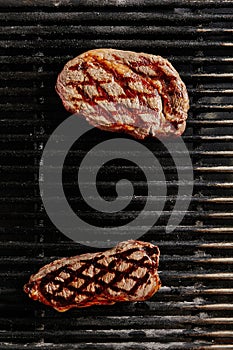 Hot Juicy Ribeye Steak on Barbecue Grill Background