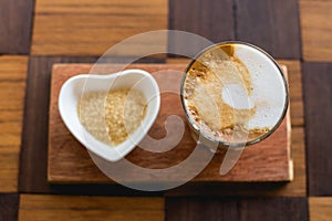 hot latte art coffee with newspaper on wooden table, vintage and