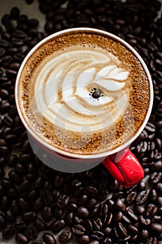 Hot latte art in red mug