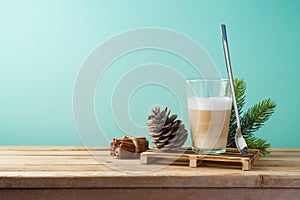 Hot Latte macchiato coffee cup on wooden table. Christmas menu