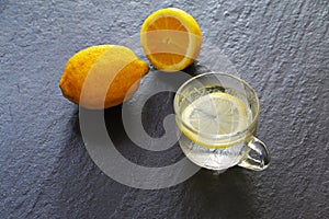 Hot lemon drink and one and half cut lemon