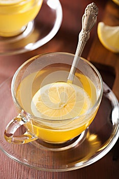 Hot lemon ginger tea in glass cup