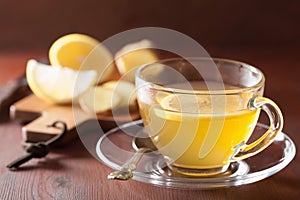 Hot lemon ginger tea in glass cup