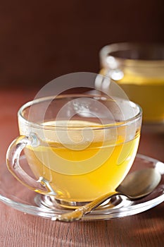 Hot lemon ginger tea in glass cup