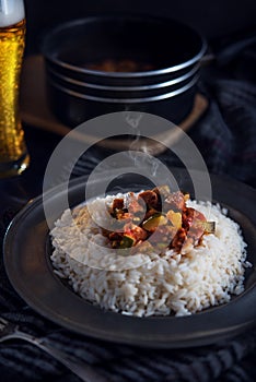 Hot letcho with rice on dark background