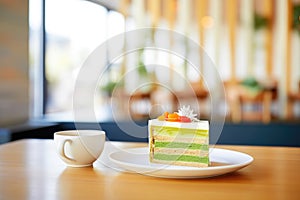 hot matcha latte with a slice of cake, caf setting photo