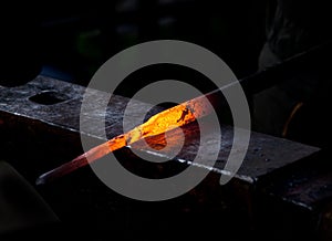 Hot metal rod on an anvil