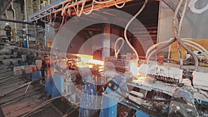 Hot Metal Tubes. Work Heavy Industry Factory. Steel Factory. Hot steel pipe production line. Red hot metal pipe