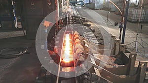 Hot Metal Tubes. Work Heavy Industry Factory. Steel Factory. Hot steel pipe production line. Red hot metal pipe