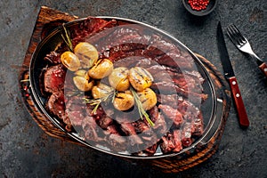 Hot Mix of grilled steaks on a plate with potatoes and rosemary