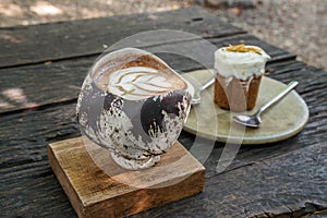 hot mocha in craft handmade cup with carrot cake