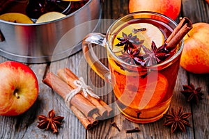 Hot mulled apple cider with cinnamon sticks, cloves and anise