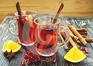 Hot mulled wine with apples, pomegranate, orange, anise and cinnamon photo