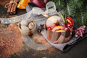 Hot mulled wine with fruits and spices in a copper pot