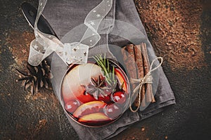 Hot mulled wine with fruits and spices in a copper pot