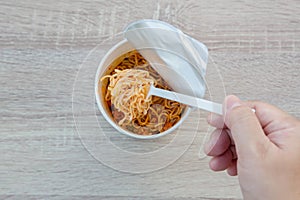 Hot noodle Cup. Noodle cup Ready made. Eating Instant Noodles with a Plastic Fork. Junk food Instant noodles are eating the popula