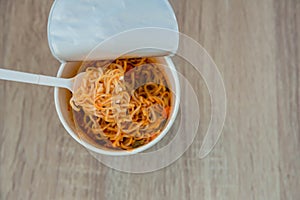 Hot noodle Cup. Noodle cup Ready made. Eating Instant Noodles with a Plastic Fork. Junk food Instant noodles are eating the popula