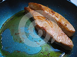 Frying salmon in a hot non-stick pan photo