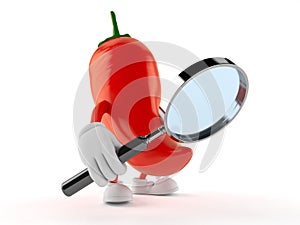 Hot paprika character looking through magnifying glass