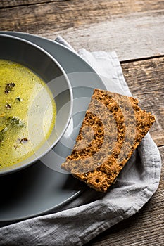 Hot pea soup with spices on the rustic background