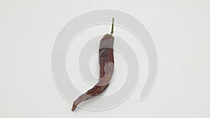 Hot pepper rotates on a white background.