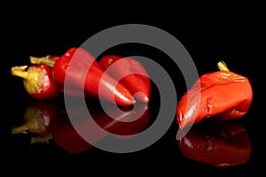 Hot pickled pepper isolated on black glass