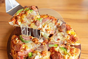 Hot pizza dip tray of pizza toppings include ham, pork, paprika and vegetables, pizza, Italian food saurian. View from side