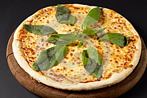 Hot pizza Margarita on a rustic wooden table.