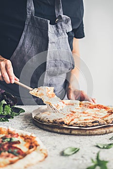 Hot pizza and slice with melting cheese