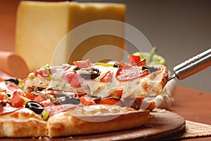 Hot pizza slice with melting cheese on a rustic wooden table