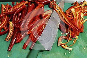 Hot red chili pepper cutting on a chopping board for food preparation