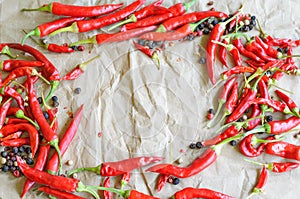 Hot red chili pepper on vintage paper background,