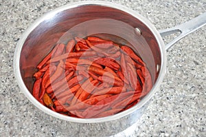 Hot red chillies cooked in a metal pot