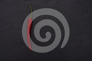 Hot red pepper on black slate background