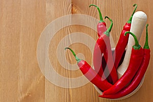 Hot red peppers and wooden pounder photo
