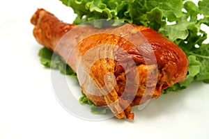 Hot roasted turkey leg served with green lettuce