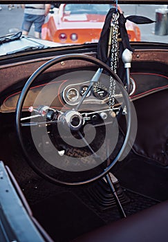 Hot Rod Retro car Cockpit parked in the old street of the European city