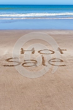 Hot Sale written in the sand of the beach on the seashore.